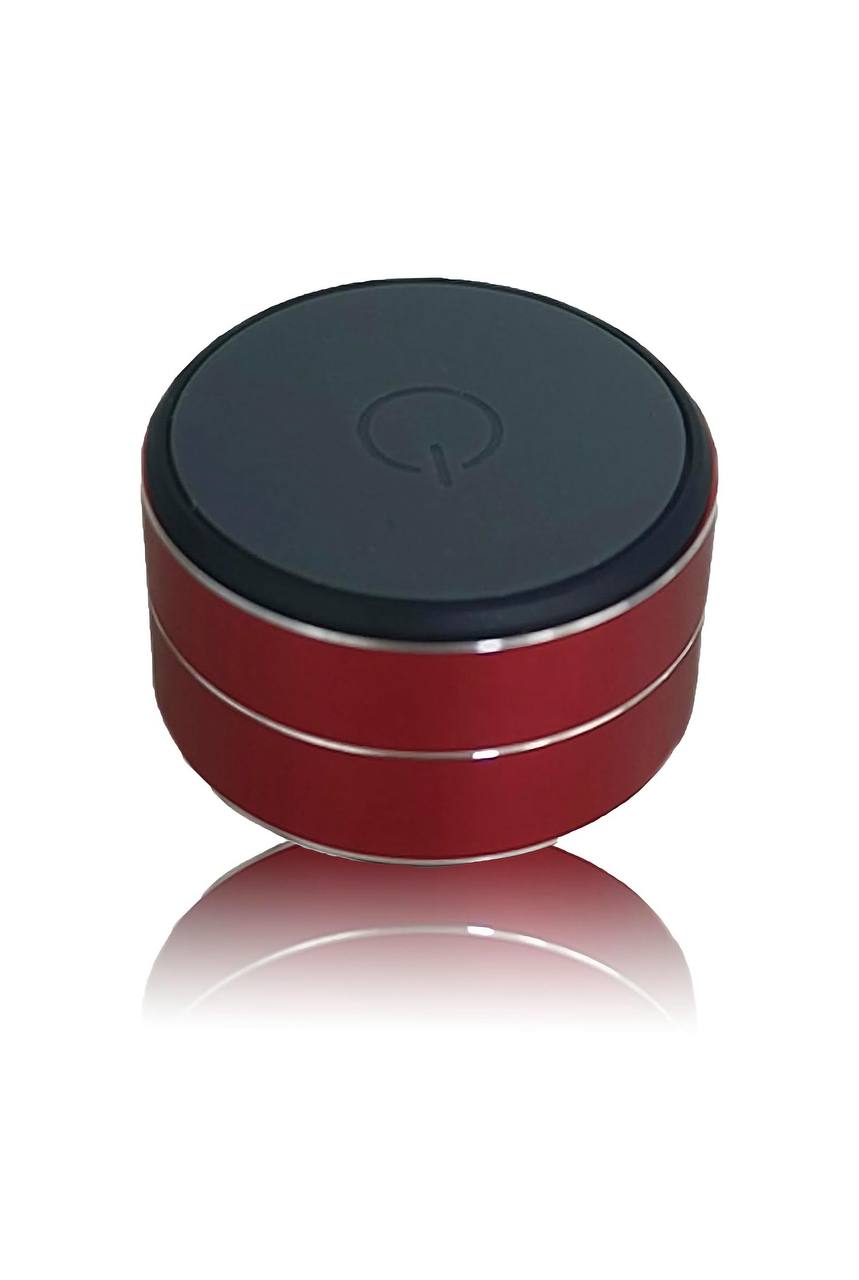 Mini portable Bluetooth speaker in red with a sleek design and power button on top.