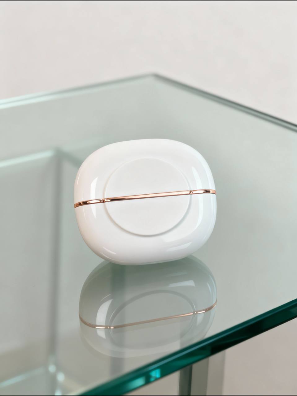 Mini straightening comb by SilkEase™ on a glass table, showcasing its sleek design and portability.